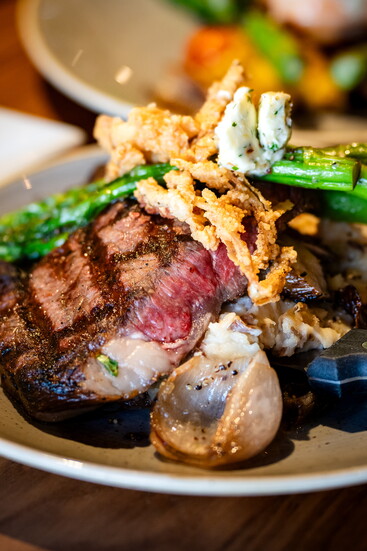 The Hearth offers elevated entrees executed with consistency, like their savory Black Angus Rib Eye Steak paired with fresh, seasonal ingredients.
