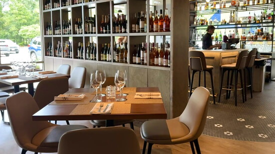 The new location has a spacious bar area and a dedicated happy hour sharing menu.