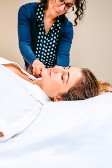 Jacqueline Fusari, standing, administers treatment in the new Wholeness Acupuncture Center. 