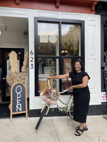 Melissa Nikosey happily posing in front of her business, Boho House.  