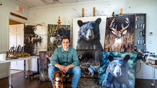 Jared Knox in his Smyrna studio with his bird dog, Huck.