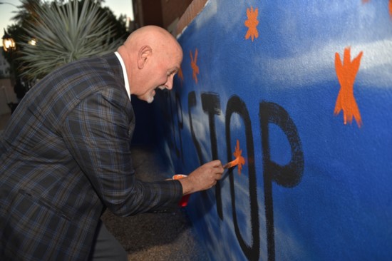 Brian Spicker of the Valley of The Sun United Way paints his asterisk.