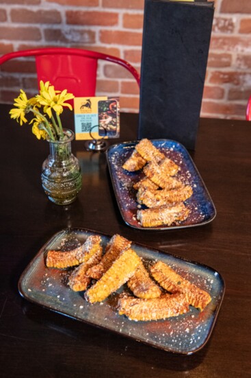 Mexican corn ribs at Tiho's - roasted cob quarters brushed with Tequila lime butter and dusted with Cotija cheese and spices.