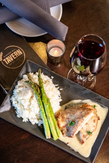 The Chicken Cordon Bleu at the Tavern is an 8 oz breaded chicken breast, Swiss cheese, Canadian ham, and Dijon cream sauce with rice & seasonal vegetables.