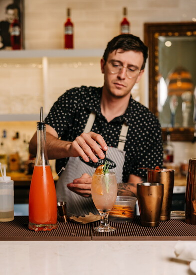Mixologist, Brandon P., puts the finishing touch on one of Pellegrini's signature cocktails.
