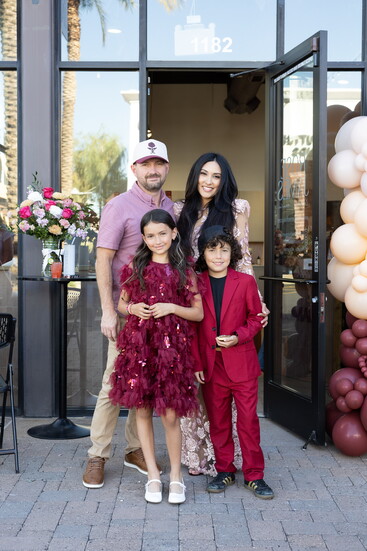 Owner and Founder Krystal Wilkinson celebrates the Rose James Grand Opening with her family.