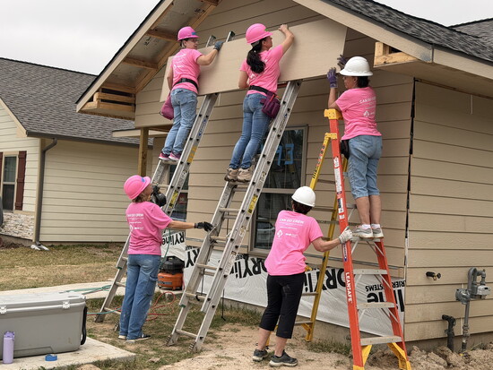 Allison Barnes, Jo Easton, and Peggy Hanrihan work from ladders while Jenny Lee and Linda Newlin support from the ground during a Can Do Crew Cedar Creek build.