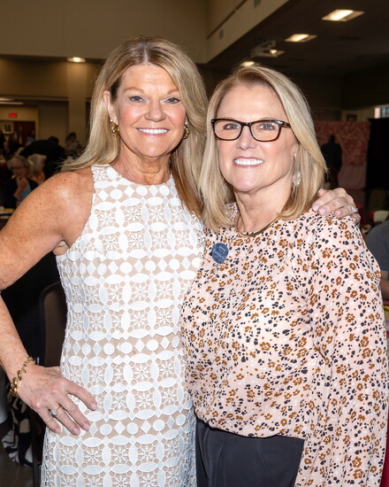Vol State supporters Linda Bolt and Cheri Anderson share a moment during the Women Empowering Education luncheon.