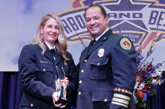 Tulsa Fire Chief Ray Driskell congratulates Firefighter of the Year, Kelly Meeks at the Rotary Club of Tulsa's Above and Beyond Awards. Photo: John Howland