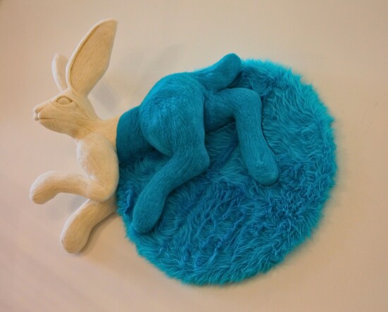 Image Description: A blue and white two-toned bunny with soft fur-like material on top of a fluffy blue circle