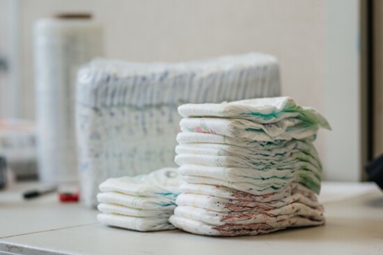 Donated diapers are organized by size for residents in need.