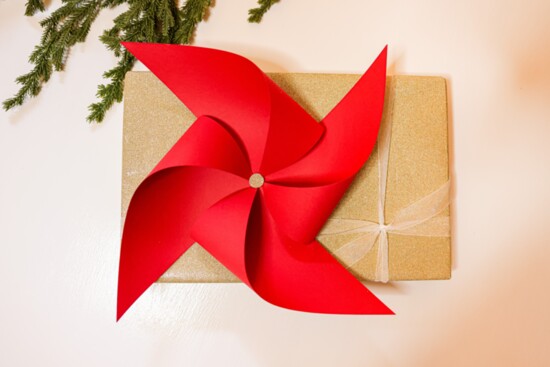 Fold paper scraps into pinwheels to adorn packages.