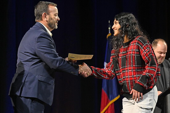 Bitiah Binoj receiving certificate from CFISD superintendent for the accomplishment as a college board national recognition scholar. 