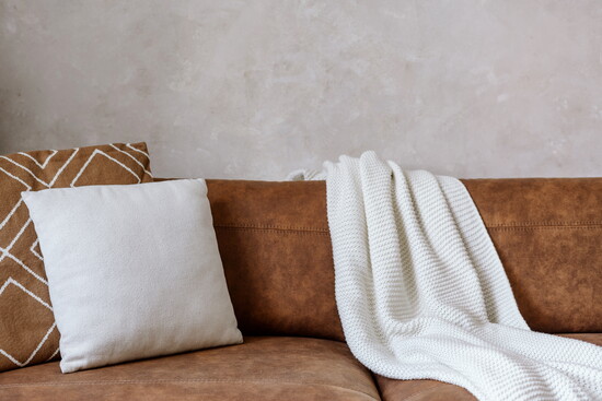 Pillows and a throw on a couch. 